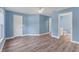 A bedroom with wood flooring and a view of an attached bathroom, offering convenience and comfort at 352 Glenwood Ave, Osprey, FL 34229