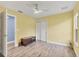 Bright bedroom features wood-look floors, modern ceiling fan, and closet with sliding doors at 352 Glenwood Ave, Osprey, FL 34229