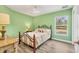 Cozy bedroom with wood floors, a window view, and natural light at 352 Glenwood Ave, Osprey, FL 34229