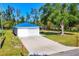 Beautiful home with a blue metal roof, a white exterior, and a long driveway at 352 Glenwood Ave, Osprey, FL 34229