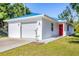 Charming home featuring a bright blue roof, a fresh white exterior, and a striking red front door at 352 Glenwood Ave, Osprey, FL 34229