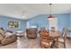Bright living room with a ceiling fan, wood flooring, and a window with plenty of natural light at 352 Glenwood Ave, Osprey, FL 34229