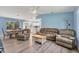 Cozy living room featuring hardwood floors, comfortable leather seating, and a bright open floor plan at 352 Glenwood Ave, Osprey, FL 34229