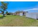 Side yard view showcasing a well maintained lawn and wooden privacy fence at 3851 Sterling Rd, Venice, FL 34293