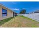 Backyard view showcasing a well maintained lawn and white privacy fence at 3851 Sterling Rd, Venice, FL 34293