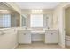 Bathroom featuring double sinks, tile flooring, and a walk-in shower with glass blocks at 3851 Sterling Rd, Venice, FL 34293