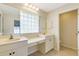 Spacious bathroom with dual sinks, vanity area, tile floors, and separate toilet room at 3851 Sterling Rd, Venice, FL 34293