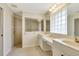 Bathroom featuring dual sinks, vanity area, tiled walk-in shower and tile flooring at 3851 Sterling Rd, Venice, FL 34293
