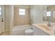 Bathroom featuring a shower and tub combination with beige tiles and a marble sink at 3851 Sterling Rd, Venice, FL 34293