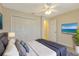 Bedroom with large closet, ceiling fan, and tv with relaxing ocean view at 3851 Sterling Rd, Venice, FL 34293