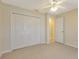 Bedroom with double closet doors, light-colored carpeting, and neutral paint at 3851 Sterling Rd, Venice, FL 34293