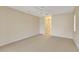 Carpeted bedroom with a ceiling fan and an adjoining doorway to an ensuite bathroom at 3851 Sterling Rd, Venice, FL 34293