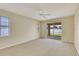 Bright bedroom featuring neutral paint, carpeting, and sliding glass doors to the backyard at 3851 Sterling Rd, Venice, FL 34293