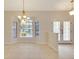 Dining area with decorative chandelier, bay window, and tile flooring at 3851 Sterling Rd, Venice, FL 34293