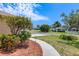 Sidewalk view of the well manicured lawn, garden and neighborhood street at 3851 Sterling Rd, Venice, FL 34293