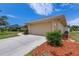 Attached two-car garage and landscaped front yard contribute to the home's curb appeal at 3851 Sterling Rd, Venice, FL 34293