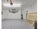 Clean and spacious garage with epoxy flooring, white walls, and a water heater at 3851 Sterling Rd, Venice, FL 34293