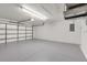 Spacious garage with gray epoxy flooring and a white interior with an automatic garage door at 3851 Sterling Rd, Venice, FL 34293