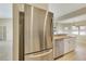 Bright kitchen featuring stainless steel appliances, white cabinetry, and tile flooring throughout at 3851 Sterling Rd, Venice, FL 34293