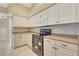 Well-lit kitchen with white cabinetry, modern appliances, and countertops at 3851 Sterling Rd, Venice, FL 34293