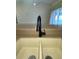 Close-up of a double bowl kitchen sink with a modern, curved black faucet at 3851 Sterling Rd, Venice, FL 34293