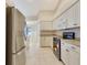 Bright kitchen with stainless steel appliances, and white cabinets at 3851 Sterling Rd, Venice, FL 34293