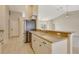 Open kitchen with stainless steel appliances, modern countertops, and views of the living room and outdoor area at 3851 Sterling Rd, Venice, FL 34293