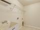 Laundry room with a sink, shelving, and wall fixtures for washer and dryer hookups at 3851 Sterling Rd, Venice, FL 34293