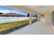 Covered lanai with screen and sliding glass doors offers outdoor living space overlooking the backyard and fencing at 3851 Sterling Rd, Venice, FL 34293