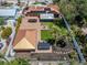 Aerial view of a home showing a large backyard with a fire pit, putting green and a covered patio with outdoor seating at 409 Armada S Rd, Venice, FL 34285