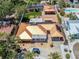 Aerial view of a home featuring a metal roof, solar panels, and a backyard with a putting green at 409 Armada S Rd, Venice, FL 34285