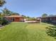 Amazing backyard featuring a putting green, built in fire pit, and a covered outdoor kitchen at 409 Armada S Rd, Venice, FL 34285