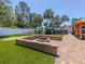 Backyard features a brick fire pit area with bench seating and an artificial turf putting green at 409 Armada S Rd, Venice, FL 34285