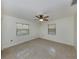 Bright and airy bedroom with neutral walls, two windows, and a ceiling fan at 409 Armada S Rd, Venice, FL 34285