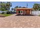 Exterior features a beautiful brick patio leading to a charming structure and outdoor living space at 409 Armada S Rd, Venice, FL 34285
