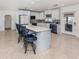 Spacious kitchen with a center island, modern appliances, white cabinetry, and access to the outdoors at 409 Armada S Rd, Venice, FL 34285