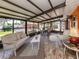 Bright sunroom with neutral furnishings, tile floors, large windows and views of outdoor space at 409 Armada S Rd, Venice, FL 34285