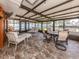 Enclosed sunroom featuring tile flooring, beamed ceiling, and outdoor views at 409 Armada S Rd, Venice, FL 34285