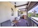 A cozy outdoor balcony with seating and a view of the surrounding green landscape at 410 Mission E Trl # B, Venice, FL 34285