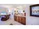 Open-concept space featuring a bar area leading into a comfortable living space and bedroom at 410 Mission E Trl # B, Venice, FL 34285