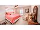 Cozy bedroom features a pink theme, large windows, and natural lighting at 410 Mission E Trl # B, Venice, FL 34285