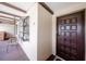 Exterior shot of condo entrance featuring a decorative window, unique lighting, and a dark brown door at 410 Mission E Trl # B, Venice, FL 34285
