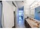 Hallway bathroom featuring a built-in closet with view into bedroom at 410 Mission E Trl # B, Venice, FL 34285