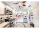 Well-equipped kitchen with stainless steel appliances, bright white cabinetry, and ample counter space at 410 Mission E Trl # B, Venice, FL 34285