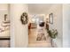 Bright entryway leading to a spacious living room with sliding glass doors and a ceiling fan at 410 Mission E Trl # B, Venice, FL 34285