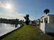 Picturesque backyard with a view of the community pond, providing a tranquil setting at 417 Via Veneto, Venice, FL 34285