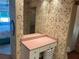 Bathroom vanity area featuring storage space, and decorative floral wallpaper at 417 Via Veneto, Venice, FL 34285