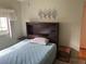 View of a bedroom with a dark wooden headboard bed frame and a window at 417 Via Veneto, Venice, FL 34285