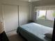 Bright bedroom featuring a comfortable bed, closet, and natural light from the window at 417 Via Veneto, Venice, FL 34285