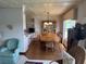 Cozy dining room with a wooden table set, adjacent to an updated kitchen at 417 Via Veneto, Venice, FL 34285